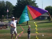 Pflugerville back pain free grandpa and grandson playing with a kite